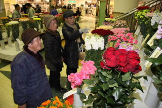 [写真] 色とりどりの花を楽しむ買い物客