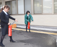 消防訓練で消火器を使う職員